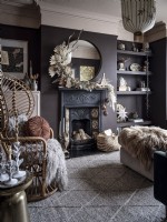 Bohemian living room with peacock chair,ornate fireplace  with mantle dressing and shelves