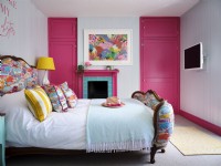 Pink  and  white bedroom with upholstered bed