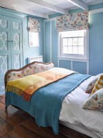 Retro coastal themed bedroom with upholstered bed