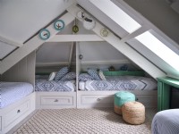 Airy loft bedroom with blue and white coastal detail