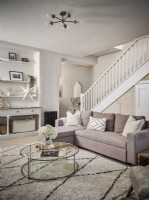 Soft furnishings in neutral tones and glass coffee table 