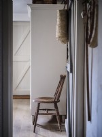 View from doorway featuring rustic brown chair and white wardrobe