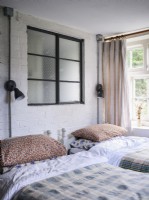 Twin bedroom with exposed brickwork 