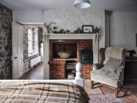 Country bedroom featuring armchair and chimney breast