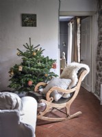 Country living room featuring seating and a Christmas tree 