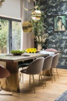 Upholstered chairs around modern dining table