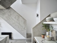 Grey concrete industrial style stairs in open plan kitchen