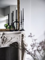 Close up of black candle sticks above fireplace