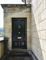 Black front door with gold knocker