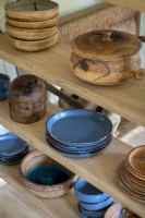 Detail of bowls and plates on wooden shelves