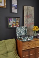 Living room detail showing a vintage record player, a wooden sideboard and framed artwork.