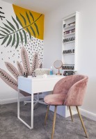 Home nail studio with a hand painted botanical wall and a pink armchair.