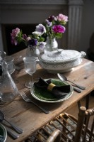 Detail of vintage crockery on wooden dining table