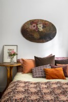Floral still life vintage painting above bed