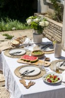 Outdoor dining table laid for lunch in summer - detail