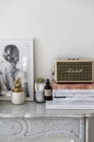Small Marshall amp, photograph and magazines on mantelpiece