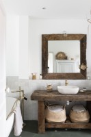 Rustic wooden unit and mirror in white country bathroom