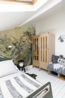 Modern childrens bedroom with jungle themed feature wall