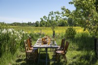 Outdoor dining table in garden with countryside views