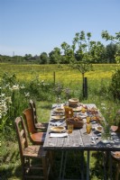 Rustic wooden outdoor dining table in country garden