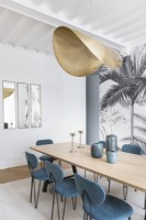 Gold pendant light over dining table in modern dining room