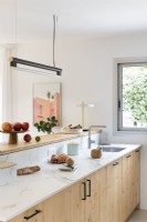 Modern wooden kitchen with white marble worktop 