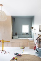 Childrens bedroom with built-in alcove bed and surrounding storage