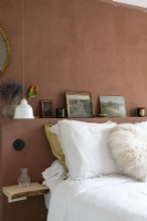 Brown painted walll and headboard in modern bedroom