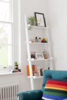 Detail of modern living room shelving with bold, colourful accents