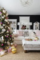 Modern black and white living room with decorated Christmas tree and white sofa