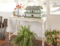 Repainted console table and vintage birdhouse in 3-season porch makeover