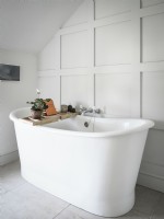 White roll top bath in classic white bathroom