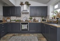 Kitchen with dark grey cabinets, slate floor tiles and vintage accessories.