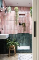 Pink and green tiled shower room with sliding pocket door