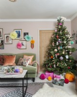 Colourfully decorated Christmas tree in feminine living room