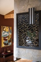 Ceramic artwork in frame on marble wall - detail