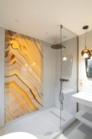 Decorative marbled glass panel in contemporary shower cubicle