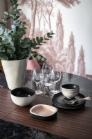 Crockery and glassware on modern dining table - detail