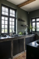 Contemporary country kitchen with black units and green walls
