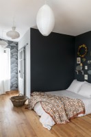 Modern country bedroom with black painted walls and white ceiling