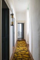 Long runner rug in narrow country corridor 