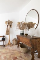 Rustic wooden table and hat stand in country hallway