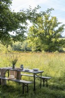 Outdoor dining table in country garden with scenic views