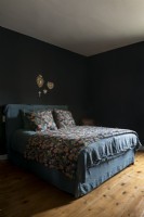 Floral bedding in black painted bedroom