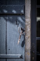 Vintage scissors hanging on external door handle - detail