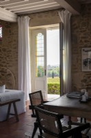 Open French windows with countryside views from country living room