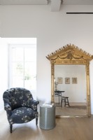 Large ornate gilded mirror and armchair