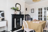 Pale pink and black art deco inspired dining room used as a work space and craft room