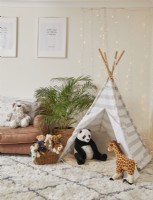 Playroom with tipi tent, soft toys, fairy lights and a fluffy rug.