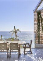 Outdoor dining area on terrace overlooking the ocean